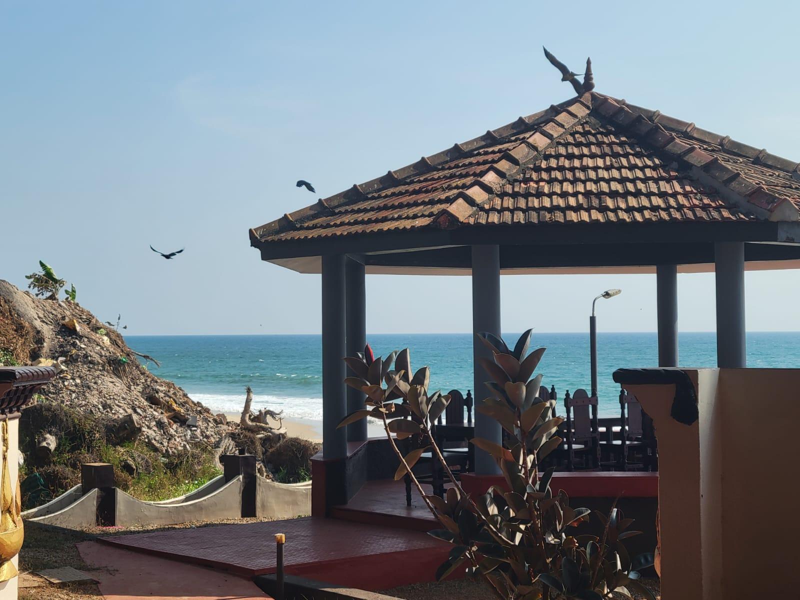 Beach at Varkala, waves and rock jetty
